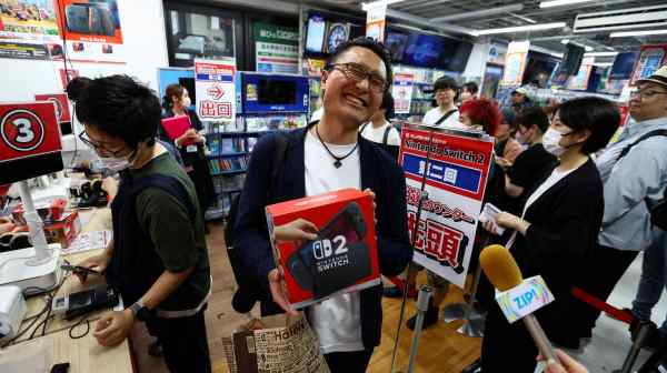 A customer holds his Nintendo Switch 2 as Nintendo started selling the new game consoles globally, at an electronics store in Tokyo on June 5.
